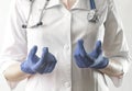 Doctor hands in blue gloves close up explaining and telling smth. Medical specialist, physician in uniform with