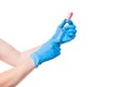 Doctor hands in blue medical gloves holding glass bottle fulled with a vaccine pink pills. Royalty Free Stock Photo