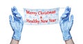 Doctor hands blue rubber medical gloves, surgical protective mask, snowflakes pattern, Merry Christmas & Healthy New Year text Royalty Free Stock Photo