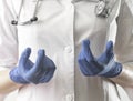 Doctor hands in gloves closeup explaining smth. Medic specialist in uniform with stethoscope close up during medical