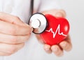 Doctor hands holding red heart and stethoscope Royalty Free Stock Photo