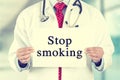 Doctor hands holding white card sign with stop smoking text message Royalty Free Stock Photo