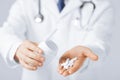 Doctor hands holding white pack and pills Royalty Free Stock Photo