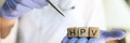 Doctor hands holding wooden cubes with word hpv Royalty Free Stock Photo