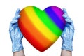 Doctor hands in medical gloves hold heart LGBT community rainbow flag color white background isolated LGBTQ pride gay lesbian love
