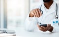 Doctor, hands and phone in hospital office for telehealth, online consultation or research. Healthcare, mobile tech and