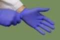 Doctor Hands Putting on Blue Nitrile Rubber Gloves Up Close