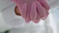 Doctor hands wearing gloves vertically close up. Cosmetologist caring sterility