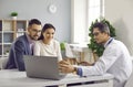 Doctor and a happy family couple looking at an ultrasound scan of a baby on a laptop computer Royalty Free Stock Photo