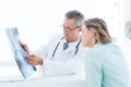 Doctor having conversation with his patient and holding xray Royalty Free Stock Photo