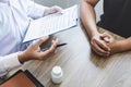 Doctor having conversation with patient while discussing explaining symptoms or counsel diagnosis health and consult treatment of Royalty Free Stock Photo