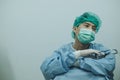 Doctor having headache and tired from work while wearing PPE suit for protect coronavirus disease. Royalty Free Stock Photo