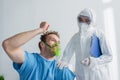 doctor in hazmat suit with clipboard Royalty Free Stock Photo