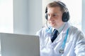Doctor in headset speaks, talks to patient. Telehealth, telemedicine, online consultation, video call conference. Medical concept Royalty Free Stock Photo