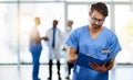 Doctor, healthcare professional and medical worker reading, holding and looking at health information and records in a Royalty Free Stock Photo