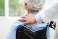 Doctor help Asian elderly woman disability patient sitting on wheelchair in hospital, medical concept