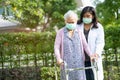 Doctor help Asian senior or elderly old lady woman walk with walker and wearing a face mask for protect safety infection and kill Royalty Free Stock Photo