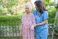 Doctor help and care Asian senior or elderly old lady woman use walker with strong health while walking at park in happy fresh Royalty Free Stock Photo