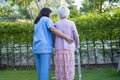 Doctor help and care Asian senior or elderly old lady woman use walker with strong health while walking at park in happy fresh Royalty Free Stock Photo