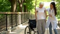 Doctor helping disabled old woman walking with crutches, recovery after trauma Royalty Free Stock Photo