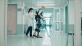Doctor is helping a female patient to walk in the exosuit