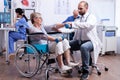 Doctor helping old disabled woman Royalty Free Stock Photo