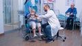 Doctor helping old woman in wheelchair Royalty Free Stock Photo