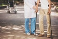 Doctor Helping Old Man Patient with Crutches.