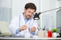 doctor at desk disinfecting hands