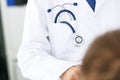 Doctor with his stethoscope in his breast pocket, closeup view or the instrument, on white. Royalty Free Stock Photo