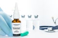 Doctor hold a vial of monoclonal antibodies nasal spray, a new treatment for coronavirus Covid-19, on a white table with some