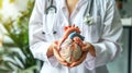 a doctor holding anatomic heart model