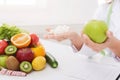 Doctor holding apple and sugar cubes in hands