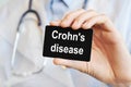 Doctor holding a paper card with text Crohn`s disease, medical concept