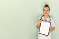 Doctor holding blank white banner. Young female doctor Royalty Free Stock Photo