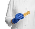 Doctor holding blister of oral contraception pills on white background, closeup Royalty Free Stock Photo