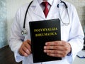 Doctor is holding a book about the polymyalgia rheumatica disease. Royalty Free Stock Photo
