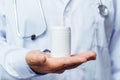 Doctor holding bottle of pills on white background. The concept of medicine, pharmacology, healthcare Royalty Free Stock Photo