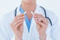 Doctor holding broken cigarette Royalty Free Stock Photo