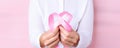 Doctor holding cancer ribon. Pink ribon breast symbol