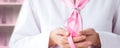 Doctor holding cancer ribon. Pink ribon breast symbol