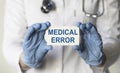 Doctor holding a card with medical error sign