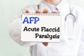 Doctor holding a card with text AFP Acute Flaccid Paralysis medical concept