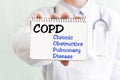 Doctor holding a card with text COPD Chronic Obstructive Pulmonary Disease medical concept