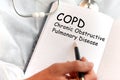 Doctor holding a card with text COPD Chronic Obstructive Pulmonary Disease, medical concept