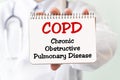 Doctor holding a card with text COPD, medical concept Royalty Free Stock Photo