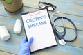 Doctor holding a card with text Crohn's disease