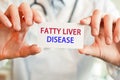 Doctor holding a card with text FATTY LIVER DISEASE, medical concept