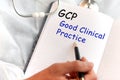 Doctor holding a card with text GCP, medical concept