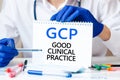 Doctor holding a card with text GCP, medical concept